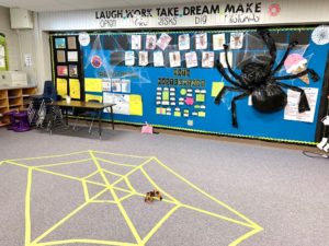 Spider themed classroom room transformation - spider web on floor and large spider on the wall