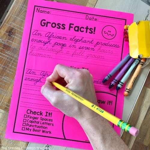Child's hand writing in cursive