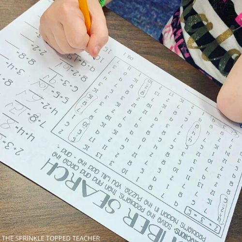 2nd grade student working on a number search math fact worksheet