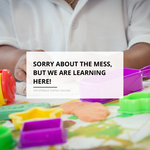 "Sorry about the mess but we are learning here" with student playing with playdoh in the background
