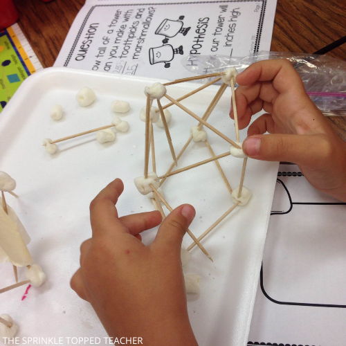Student building a STEM tower with marshmallows and toothpicks in a lesson on the scientific method