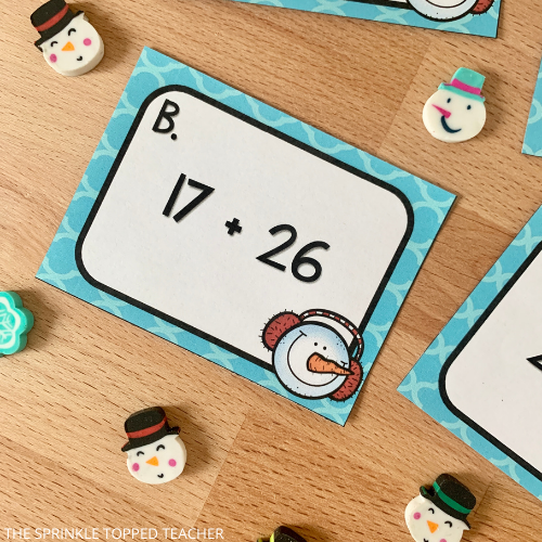 17+26 task card for student to practice their addition math facts, image includes snowman erasers