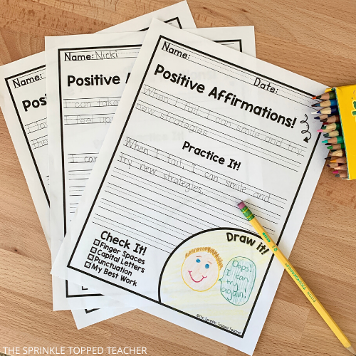 3 Positive affirmations for kids handwriting worksheets laid out with pencil and colored pencils