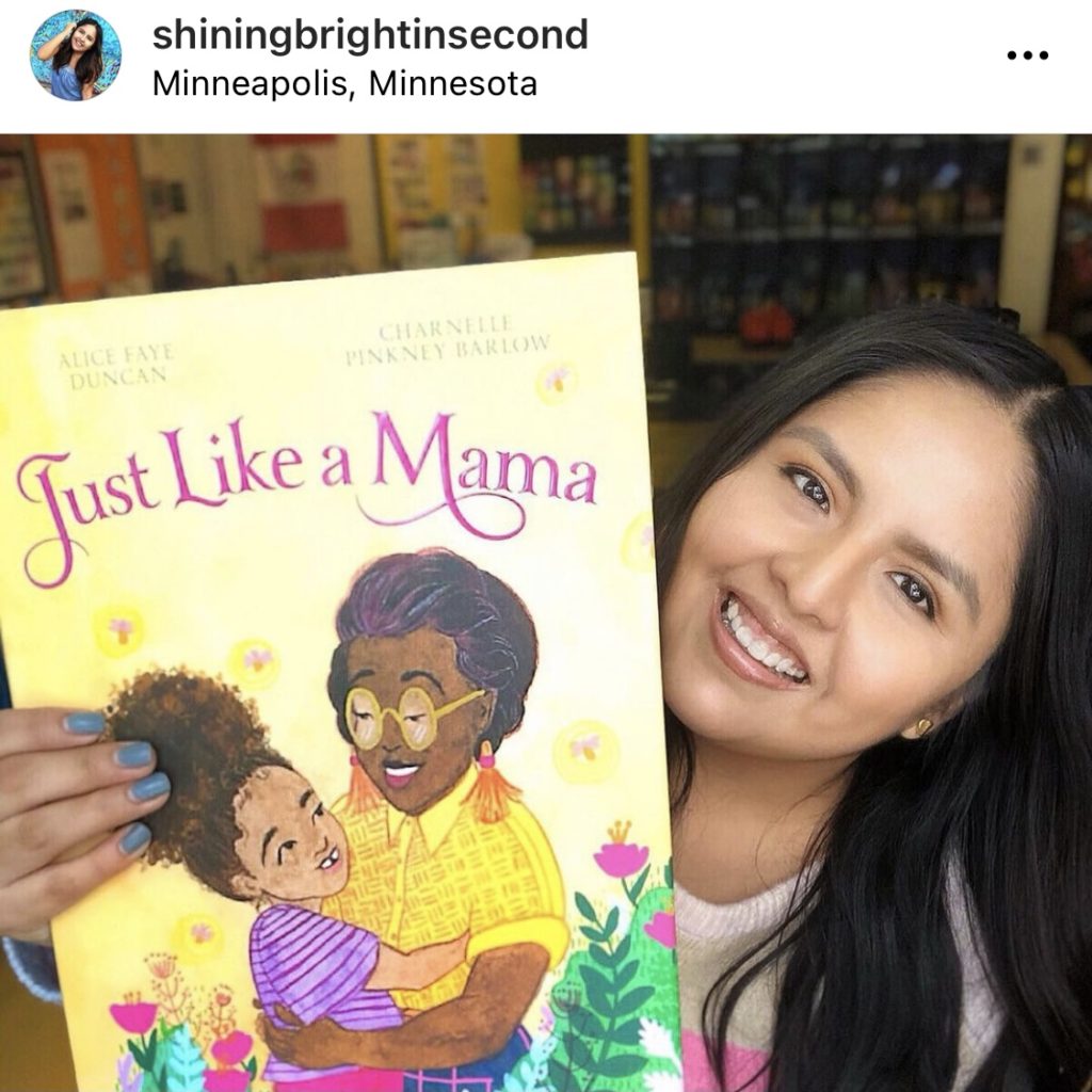 Teacher smiling holding the book "Just Like Mama" @shiningbrightinsecond