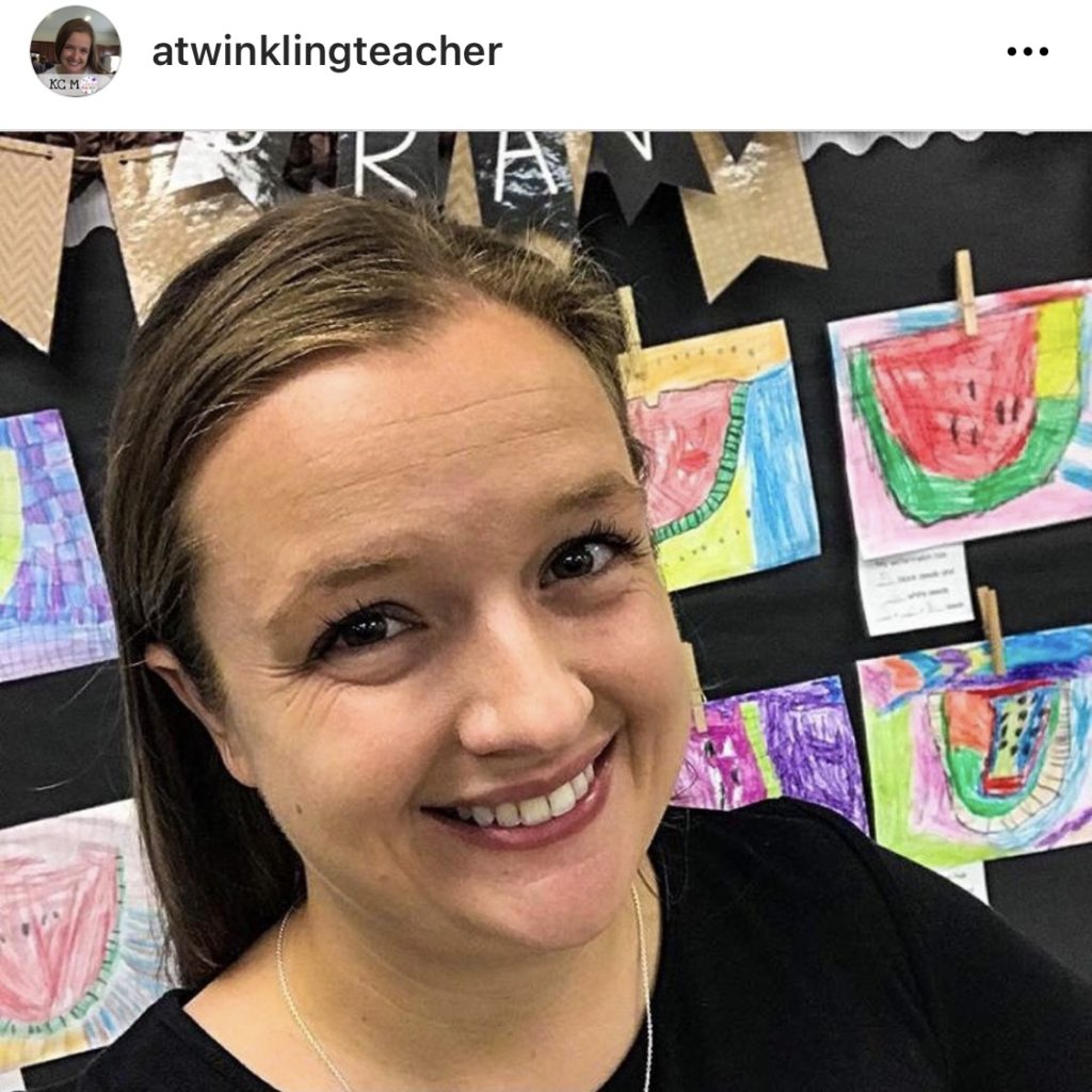 Teacher smiling in front of watermelon themed bulletin board @atwinklingteacher