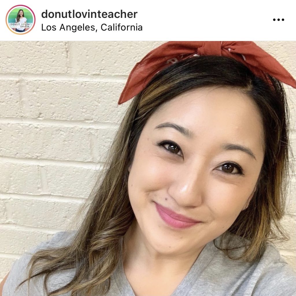 Teacher with bow in hair against brick wall @donutlovinteacher