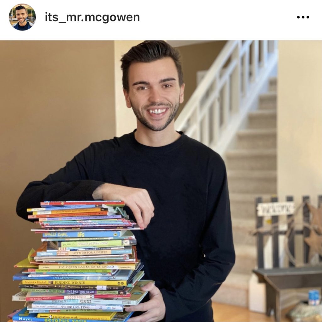 Teacher holding a stack of books @its_mr.mcgowen