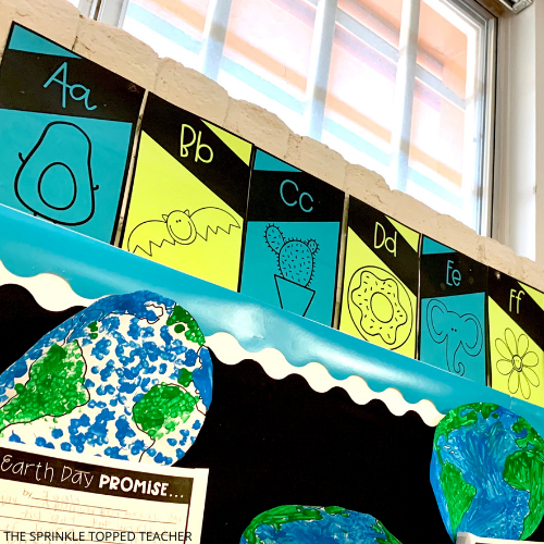 alphabet and number classroom posters on bulletin board