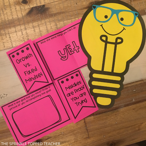 Student's growth mindset activity with lightbulb craft on desk 