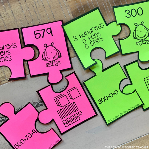 Place Value Puzzle Monster pieces that describe hundreds, tens and ones place in a variety of ways including numbers, equations, words and visuals. Part of the fall activities for 2nd grade bundle.