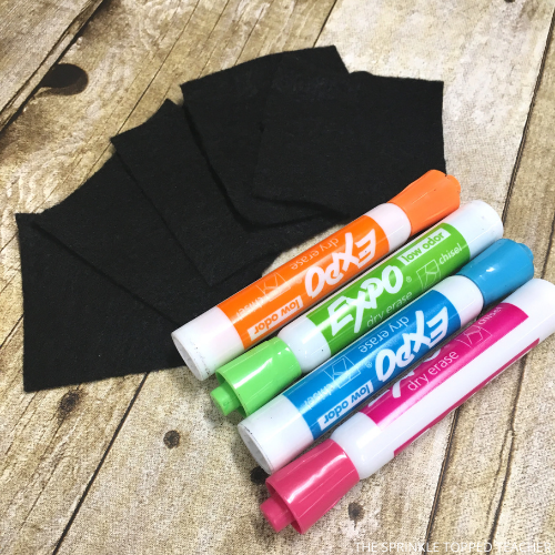 Image of Expo markers in orange, green, blue and pink. Also included are five squares of black felt to use as erasers.