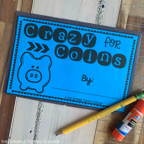 Blue half page from the money activity for second grade. It says, "Crazy for Coins" and has a place to add a student name. There are also a student pencil and glue stick shown.