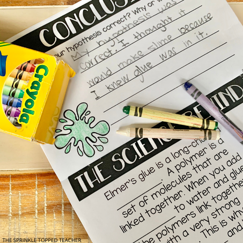 Children's crayons are on the conclusion page of the easy slime experiment.