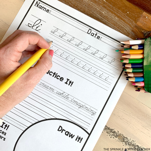 A student works on a cursive handwriting worksheet featuring the letter I using a number two pencil.