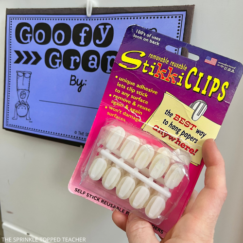Teacher holding a clasroom Amazon favorite, Stikki Clips with a graphing bulletin board in the background